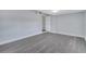 Neutral bedroom featuring modern gray floors, fresh paint, and a bright lighting fixture at 7 Garvey Ln, Frostproof, FL 33843