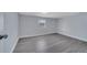 Light-filled bedroom featuring gray floors, neutral walls, and white trim at 7 Garvey Ln, Frostproof, FL 33843