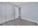Bedroom with closet space, fresh paint, modern gray floors, and an easy-access doorway at 7 Garvey Ln, Frostproof, FL 33843