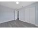 Bedroom with closet space, fresh paint, modern gray floors, and an easy-access doorway at 7 Garvey Ln, Frostproof, FL 33843
