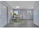 Bright dining area with a modern table set, complemented by natural light and neutral decor at 7 Garvey Ln, Frostproof, FL 33843