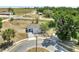 Aerial view of a single-story home with front yard and driveway on a cul-de-sac at 7 Garvey Ln, Frostproof, FL 33843