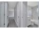 Hallway showcasing access to a marble-tiled bathroom and an open floor plan, connecting key areas at 7 Garvey Ln, Frostproof, FL 33843