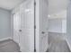 Hallway featuring doors, fresh paint, and modern gray floors, providing a seamless flow throughout the home at 7 Garvey Ln, Frostproof, FL 33843