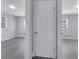 Hallway showcasing access to multiple rooms and modern gray floors, connecting key areas of the home at 7 Garvey Ln, Frostproof, FL 33843