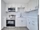 Close up of the kitchen with stainless appliances and white cabinets at 7 Garvey Ln, Frostproof, FL 33843