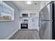 Well-lit kitchen featuring stainless steel appliances and bright white cabinets at 7 Garvey Ln, Frostproof, FL 33843