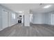 Open floor plan with gray floors that combines living area and kitchen at 7 Garvey Ln, Frostproof, FL 33843