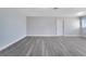 Spacious living room with gray floors and white trim at 7 Garvey Ln, Frostproof, FL 33843