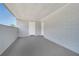 Covered patio with solid walls and floor, and a white door at 7 Garvey Ln, Frostproof, FL 33843