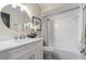 Bathroom featuring a vanity with marble countertop and shower-tub combo with a white tiled surround at 741 Orange Ave, Longwood, FL 32750