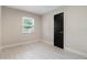 Bedroom with natural light and a sleek, black closet door offering ample storage at 741 Orange Ave, Longwood, FL 32750