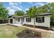 Charming single-story home featuring a bright blue door, manicured landscaping, and a freshly painted exterior at 741 Orange Ave, Longwood, FL 32750