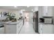 Modern kitchen featuring white cabinets, stainless steel appliances, and sleek countertops, ideal for culinary enthusiasts at 741 Orange Ave, Longwood, FL 32750