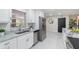 Modern kitchen featuring white cabinets, stainless steel appliances, and sleek countertops, ideal for culinary enthusiasts at 741 Orange Ave, Longwood, FL 32750