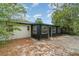 Rear view of house featuring white and dark siding, and windows, overlooking a spacious backyard with brick patio at 741 Orange Ave, Longwood, FL 32750
