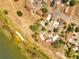 Aerial view of a community near a lake surrounded by mature trees at 75 Garrison Ln, Frostproof, FL 33843