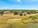 Aerial view of a lakeside community with a boat near the lake at 75 Garrison Ln, Frostproof, FL 33843
