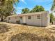 Exterior shot of home's backyard, featuring a neutral color scheme at 75 Garrison Ln, Frostproof, FL 33843