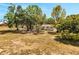 Spacious backyard surrounded by mature trees providing ample shade at 75 Garrison Ln, Frostproof, FL 33843