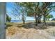 A beautiful view from the back door, featuring mature trees and a lakefront at 75 Garrison Ln, Frostproof, FL 33843