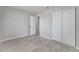 Bedroom with tile flooring, neutral walls, and closet with double doors at 75 Garrison Ln, Frostproof, FL 33843