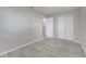 Bedroom features wood-look tile floors, closet, and neutral color scheme at 75 Garrison Ln, Frostproof, FL 33843