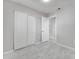 Bedroom with tile flooring, neutral walls, a light and bright ceiling, and closet with double doors at 75 Garrison Ln, Frostproof, FL 33843