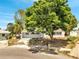 Charming single-story home with a mature shade tree and fresh exterior paint at 75 Garrison Ln, Frostproof, FL 33843