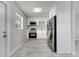 Modern kitchen featuring white cabinetry and stainless steel appliances, blending functionality with style at 75 Garrison Ln, Frostproof, FL 33843