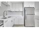 Efficient kitchen featuring sleek appliances, white cabinets, and plenty of counter space at 75 Garrison Ln, Frostproof, FL 33843