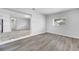 Bright, open living room features neutral paint, wood flooring, and natural light from a single window at 75 Garrison Ln, Frostproof, FL 33843