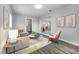 Cozy living room showcasing neutral tones, stylish furniture, and seamless flow into the dining area at 75 Garrison Ln, Frostproof, FL 33843