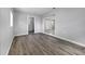 Open living room features neutral paint, wood flooring, and lots of natural light at 75 Garrison Ln, Frostproof, FL 33843