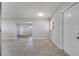 Bright, open living room features neutral paint, tile flooring, and natural light from a single window at 75 Garrison Ln, Frostproof, FL 33843