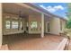 Spacious covered back porch with wood flooring, ceiling fan, and a view of the backyard at 902 Hire Cir, Ocoee, FL 34761