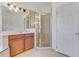 This bathroom features a vanity, glass shower, and neutral tile at 902 Hire Cir, Ocoee, FL 34761