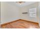 Clean bedroom with hardwood floors, natural light, ceiling fan, and shelf on wall at 902 Hire Cir, Ocoee, FL 34761
