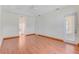 Large bedroom with hardwood floors, natural light, and door to patio at 902 Hire Cir, Ocoee, FL 34761