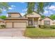 Charming two-story home with a three-car garage, well-manicured lawn, and beautiful landscaping at 902 Hire Cir, Ocoee, FL 34761