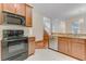 Kitchen with granite countertops, stainless steel appliances, and white tiled floors at 902 Hire Cir, Ocoee, FL 34761