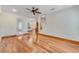 Open living room with hardwood floors, ceiling fan, and staircase leading to the second floor at 902 Hire Cir, Ocoee, FL 34761