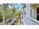 Stylish condo balcony showcasing tree-lined views and charming architectural details along the street at 921 Begonia Rd # 302, Celebration, FL 34747
