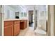 Bright bathroom with double sink vanity, white tile flooring, glass-enclosed shower, and a toilet at 921 Begonia Rd # 302, Celebration, FL 34747