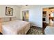 Cozy bedroom with mirrored closet doors leading to laundry area at 921 Begonia Rd # 302, Celebration, FL 34747