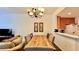 Open dining room featuring long wood table, tufted chairs, and neutral paint with direct view to kitchen area at 921 Begonia Rd # 302, Celebration, FL 34747