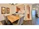 Open dining area with view into the kitchen featuring wood flooring and table with comfortable upholstered chairs at 921 Begonia Rd # 302, Celebration, FL 34747