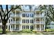 Condominium exterior featuring a facade with multiple balconies and white railings and black window shutters at 921 Begonia Rd # 302, Celebration, FL 34747