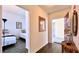 Hallway showing wood floors, bedroom, and front door with decorative table at 921 Begonia Rd # 302, Celebration, FL 34747