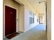 A well-lit hallway with a red apartment door and view of the exit sign at 921 Begonia Rd # 302, Celebration, FL 34747